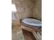 A bathroom with a jacuzzi tub with tiled walls, marble surround, and decorative fixtures at 3480 E Hacienda Ave, Las Vegas, NV 89120
