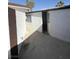 House exterior showing a backyard entrance with an open door and brown accents on the walls at 3480 E Hacienda Ave, Las Vegas, NV 89120