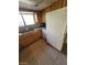 This shows the kitchen sink under the window and white refrigerator in the corner at 3480 E Hacienda Ave, Las Vegas, NV 89120