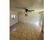 Spacious living room with neutral paint and tile floors, ready to personalize at 3480 E Hacienda Ave, Las Vegas, NV 89120