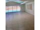 Spacious living room with large windows showcasing the pool, complemented by tiled flooring at 3480 E Hacienda Ave, Las Vegas, NV 89120
