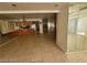 Inviting living room with mirrored walls, tiled floors, and view of kitchen area at 3480 E Hacienda Ave, Las Vegas, NV 89120
