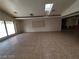 Bright open-plan living room featuring high ceilings, skylights, and tile flooring for easy maintenance at 3480 E Hacienda Ave, Las Vegas, NV 89120