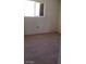 Cozy bedroom featuring neutral walls and ample natural light from the window at 3601 Valley Forge Ave, Las Vegas, NV 89110