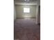 View of a carpeted room with a window providing natural light at 3601 Valley Forge Ave, Las Vegas, NV 89110