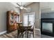 Cozy dining area with wood furniture, a ceiling fan, and a view of a fireplace at 3609 Indigo Flower St # 1, North Las Vegas, NV 89084