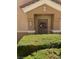 Exterior view of front door surrounded by clipped hedges, number 1 on the wall at 3609 Indigo Flower St # 1, North Las Vegas, NV 89084