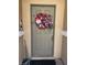 Close up of a gray front door adorned with patriotic wreath and dark doormat at 3609 Indigo Flower St # 1, North Las Vegas, NV 89084