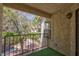 Balcony view with mature trees, a black railing, and a green astroturf rug at 3609 Melonies Dr # 93, Las Vegas, NV 89103
