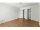 Bright bedroom featuring a wood floor and closet with white sliding doors at 3609 Melonies Dr # 93, Las Vegas, NV 89103