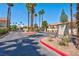 Gated community entrance with palm trees and manicured landscaping enhances curb appeal at 3609 Melonies Dr # 93, Las Vegas, NV 89103