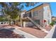Charming condo with stucco exterior, red tile roof, and inviting staircase to the second level entrance at 3609 Melonies Dr # 93, Las Vegas, NV 89103
