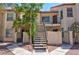 Inviting condo exterior with stairs leading to upper units, enhanced by lush landscaping and desert-friendly gravel at 3609 Melonies Dr # 93, Las Vegas, NV 89103