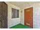 Building entryway featuring a secure iron gate, adjacent window and a solid door at 3609 Melonies Dr # 93, Las Vegas, NV 89103