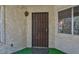 Inviting entryway featuring a secure iron gate, stucco walls, and an exterior light fixture at 3609 Melonies Dr # 93, Las Vegas, NV 89103