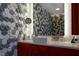 Stylish bathroom featuring geometric tile wall, modern vanity, and illuminated mirror at 3750 Las Vegas Blvd # 4303, Las Vegas, NV 89158