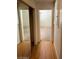 Hallway with gleaming hardwood floors and mirrored closet doors reflects the light at 3797 Monument St, Las Vegas, NV 89121