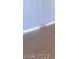 Hardwood floors extend to a window with vertical blinds in this naturally lit living room at 3797 Monument St, Las Vegas, NV 89121