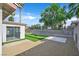 A backyard features a sunroom, artificial grass, a stone ground cover and a block wall in this image at 3849 Boca Chica Ave, Las Vegas, NV 89120