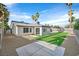 This backyard offers artificial grass, stone ground cover, a concrete patio, and sunroom for outdoor enjoyment at 3849 Boca Chica Ave, Las Vegas, NV 89120