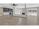 Open-concept living space showcasing wood flooring, kitchen with stainless appliances, and a fireplace at 3849 Boca Chica Ave, Las Vegas, NV 89120
