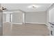 Large open living room with gray wood floors, neutral walls, and contemporary lighting fixture at 3849 Boca Chica Ave, Las Vegas, NV 89120