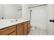 Bright bathroom featuring a bathtub with shower, tiled shower walls and vanity with drawers at 4205 Thicket Ave, North Las Vegas, NV 89031