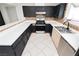 Bright kitchen featuring black cabinets, stainless steel appliances, white countertops and tile flooring at 4205 Thicket Ave, North Las Vegas, NV 89031