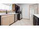 View of the kitchen featuring stainless steel refrigerator, stainless steel dishwasher and tan lower cabinets at 4205 Thicket Ave, North Las Vegas, NV 89031