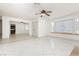 Open-concept living area with tile floors, a ceiling fan, and natural light at 4205 Thicket Ave, North Las Vegas, NV 89031