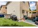 Backyard with artificial turf, seating under shade, and sliding door access at 4249 Fleet Dancer St, Las Vegas, NV 89129