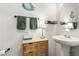 Cozy powder room features a pedestal sink and charming wood cabinet at 4249 Fleet Dancer St, Las Vegas, NV 89129