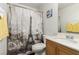 Charming bathroom features an Eiffel Tower shower curtain, a toilet, and a wooden vanity at 4249 Fleet Dancer St, Las Vegas, NV 89129