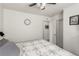 Well-lit bedroom showcasing a ceiling fan, a bed with a quilt, and minimalist decor at 4249 Fleet Dancer St, Las Vegas, NV 89129