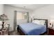 Cozy bedroom with a large window, a blue quilt, and soft pillows on the bed at 4249 Fleet Dancer St, Las Vegas, NV 89129