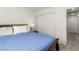 Comfortable bedroom featuring a blue quilt, soft pillows, and a closet for ample storage at 4249 Fleet Dancer St, Las Vegas, NV 89129