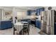 Bright kitchen features stainless steel appliances, stylish blue cabinets, and wood floors at 4249 Fleet Dancer St, Las Vegas, NV 89129