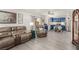 Open-concept living room showcases modern furniture, light gray floors, and kitchen in background at 4249 Fleet Dancer St, Las Vegas, NV 89129