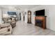 Spacious living room featuring wood-look flooring, a fireplace, and view into an adjacent kitchen at 4249 Fleet Dancer St, Las Vegas, NV 89129