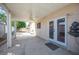 Spacious covered back patio with fan, double glass doors and a water feature, perfect for outdoor living at 4409 Rosebank Cir, Las Vegas, NV 89108