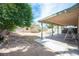Expansive backyard with mature trees, covered patio and a storage shed, perfect for outdoor activities and relaxation at 4409 Rosebank Cir, Las Vegas, NV 89108