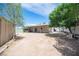 Expansive backyard with mature trees and a covered patio, perfect for outdoor living at 4409 Rosebank Cir, Las Vegas, NV 89108
