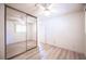 Bedroom with neutral walls, mirrored closet doors, wood-look floors, and a ceiling fan at 4409 Rosebank Cir, Las Vegas, NV 89108