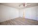 Bedroom with neutral walls, wood-look flooring, and a ceiling fan with light at 4409 Rosebank Cir, Las Vegas, NV 89108