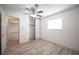 Clean bedroom with wood look floors, a ceiling fan and a sliding door closet at 4409 Rosebank Cir, Las Vegas, NV 89108