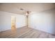 This bedroom includes neutral walls, wood-look floors, and access to a bathroom at 4409 Rosebank Cir, Las Vegas, NV 89108