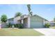Inviting single-story home with a lush green lawn and a convenient two-car garage at 4409 Rosebank Cir, Las Vegas, NV 89108