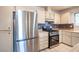 Close-up of the stainless steel refrigerator and gas stove in the kitchen area at 4409 Rosebank Cir, Las Vegas, NV 89108