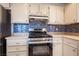 Gas stove with stainless steel appliances and a mosaic tile backsplash in kitchen at 4409 Rosebank Cir, Las Vegas, NV 89108