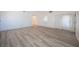 Spacious living room with new flooring, bright windows and light green door at 4409 Rosebank Cir, Las Vegas, NV 89108